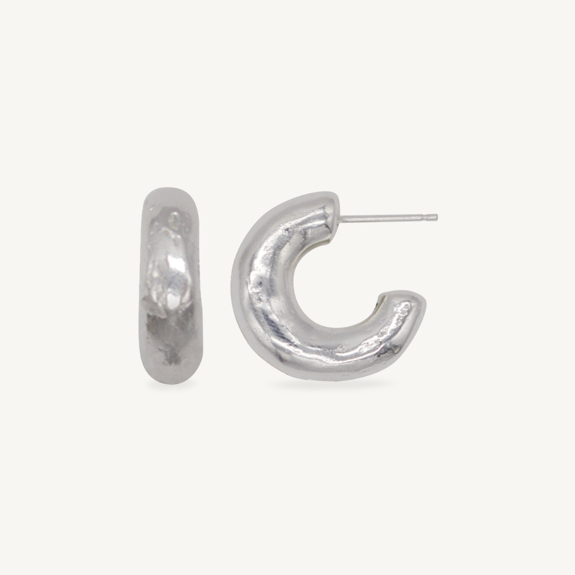 These chunky recycled silver statement hoop earrings with an organic texture are ethically handmade in London by Folde Jewellery.