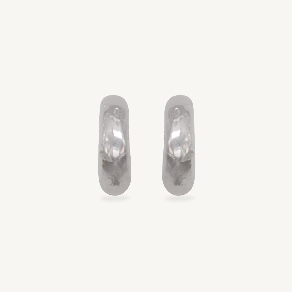 These chunky recycled silver statement hoop earrings with an organic texture are ethically handmade in London by Folde Jewellery.