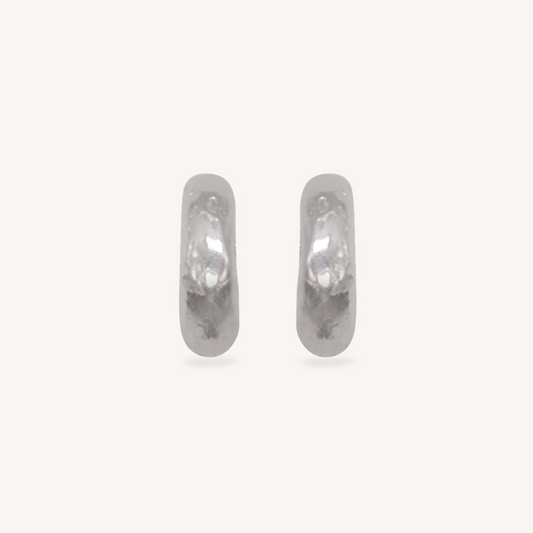 These chunky recycled silver statement hoop earrings with an organic texture are ethically handmade in London by Folde Jewellery.