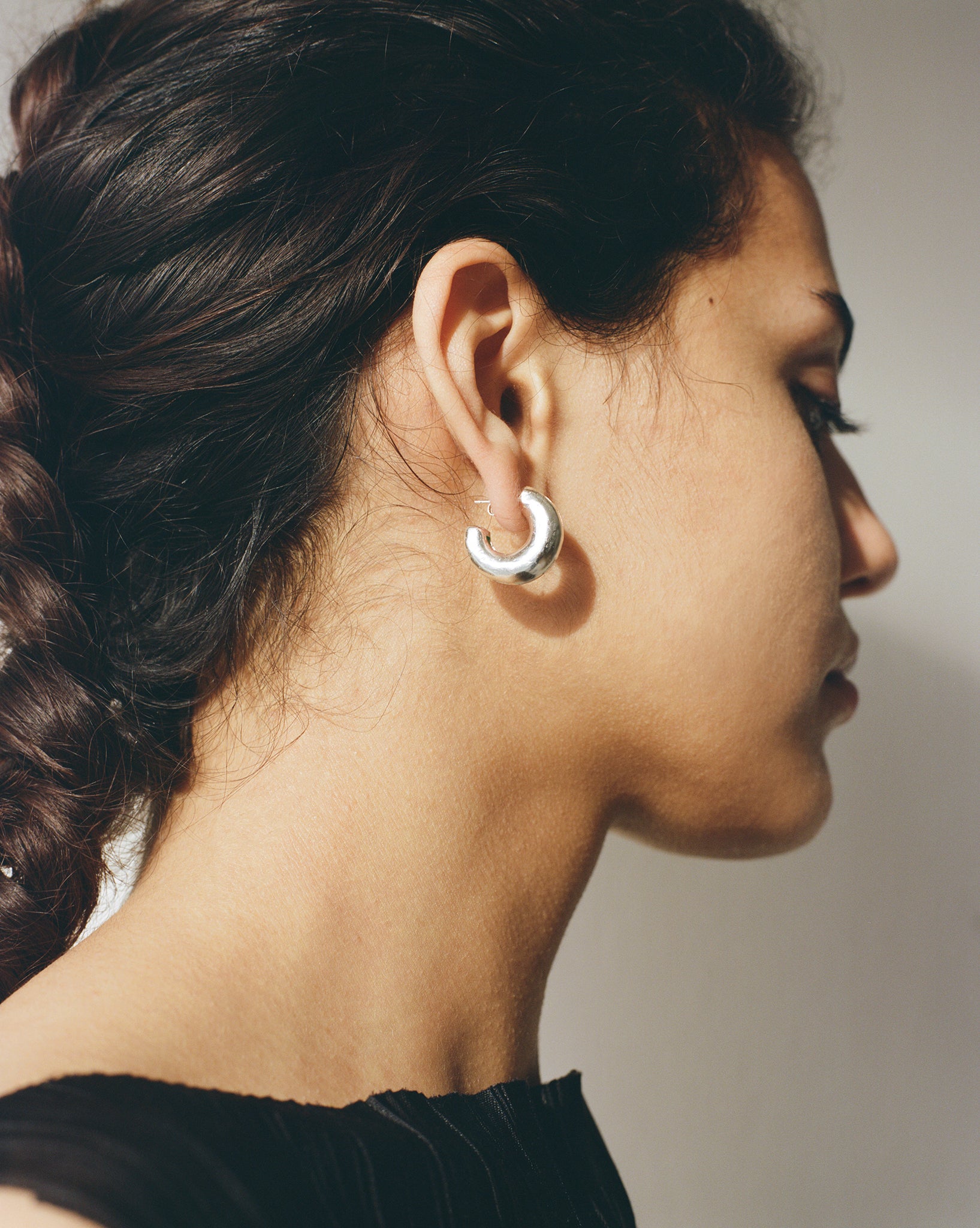 These chunky recycled silver statement hoop earrings with an organic texture are ethically handmade in London by Folde Jewellery.