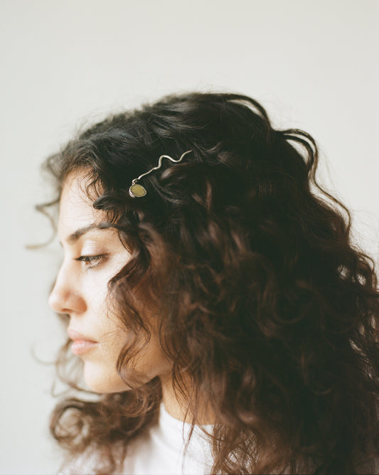 These statement recycled silver hair slides feature organic texture and a disc of ethically sourced highland horn, all ethically handmade in London by Folde Jewellery.