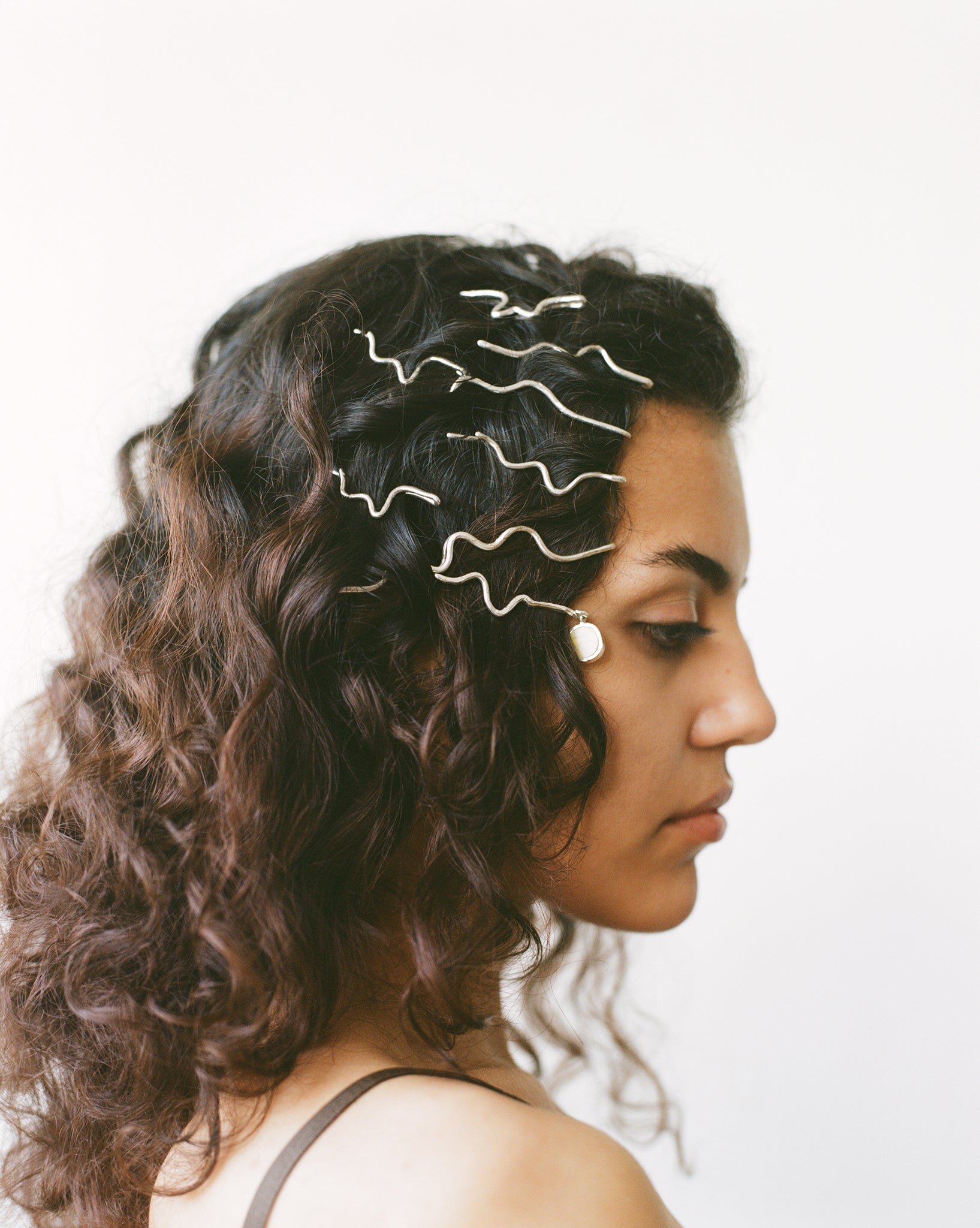 These statement recycled silver hair slides feature organic texture and a disc of ethically sourced highland horn, all ethically handmade in London by Folde Jewellery.