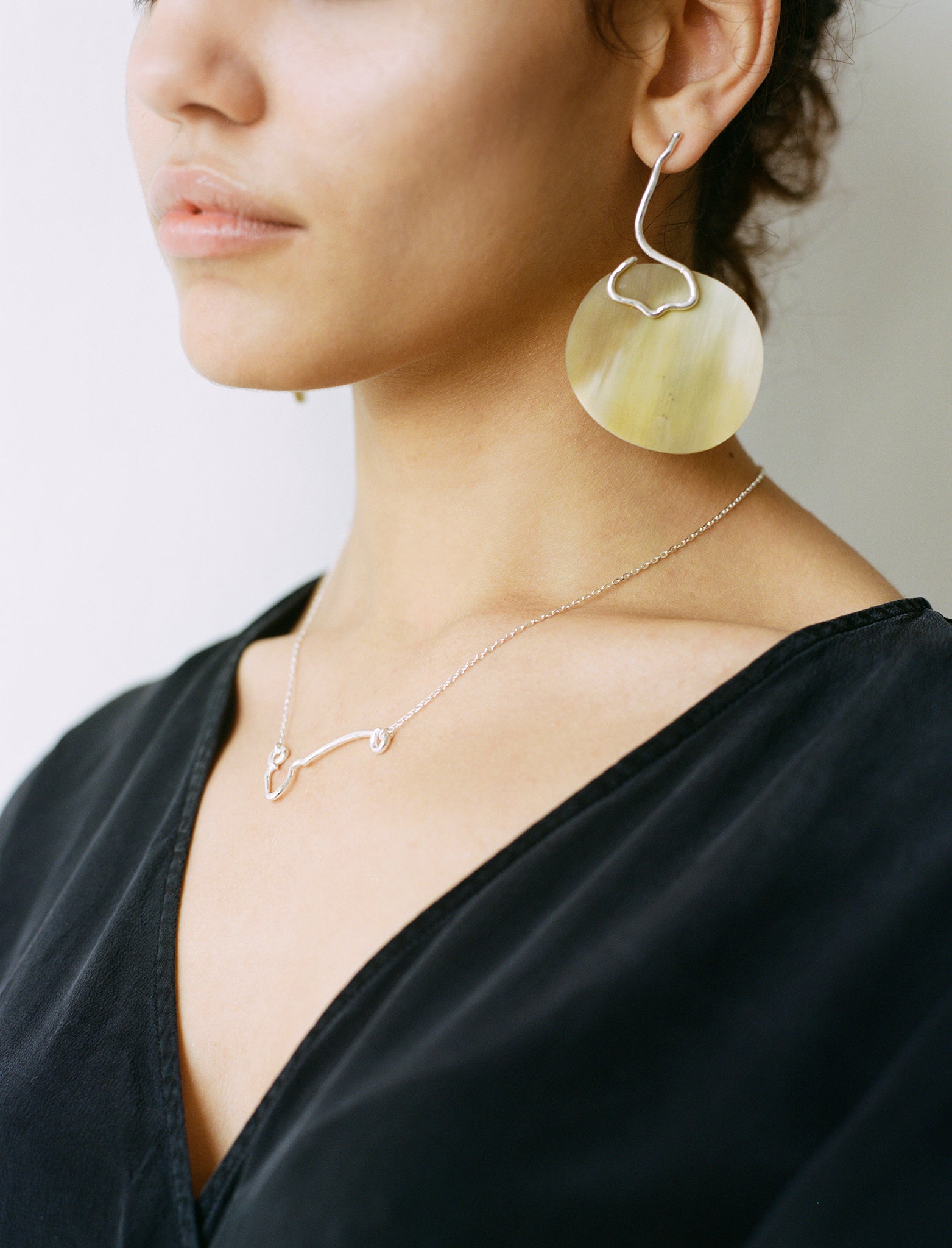 The IDA necklace is a sculptural elegant silver line necklace featuring organic texture ethically handmade in London from recycled silver by Folde Jewellery.