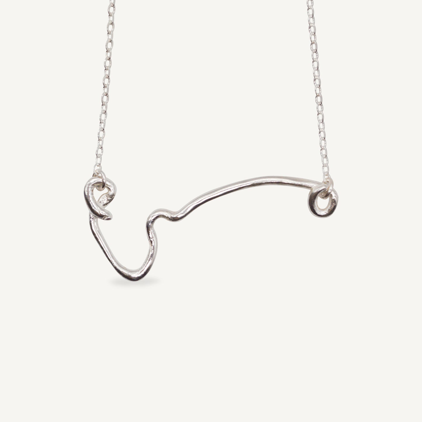 The IDA necklace is a sculptural elegant silver line necklace featuring organic texture ethically handmade in London from recycled silver by Folde Jewellery.